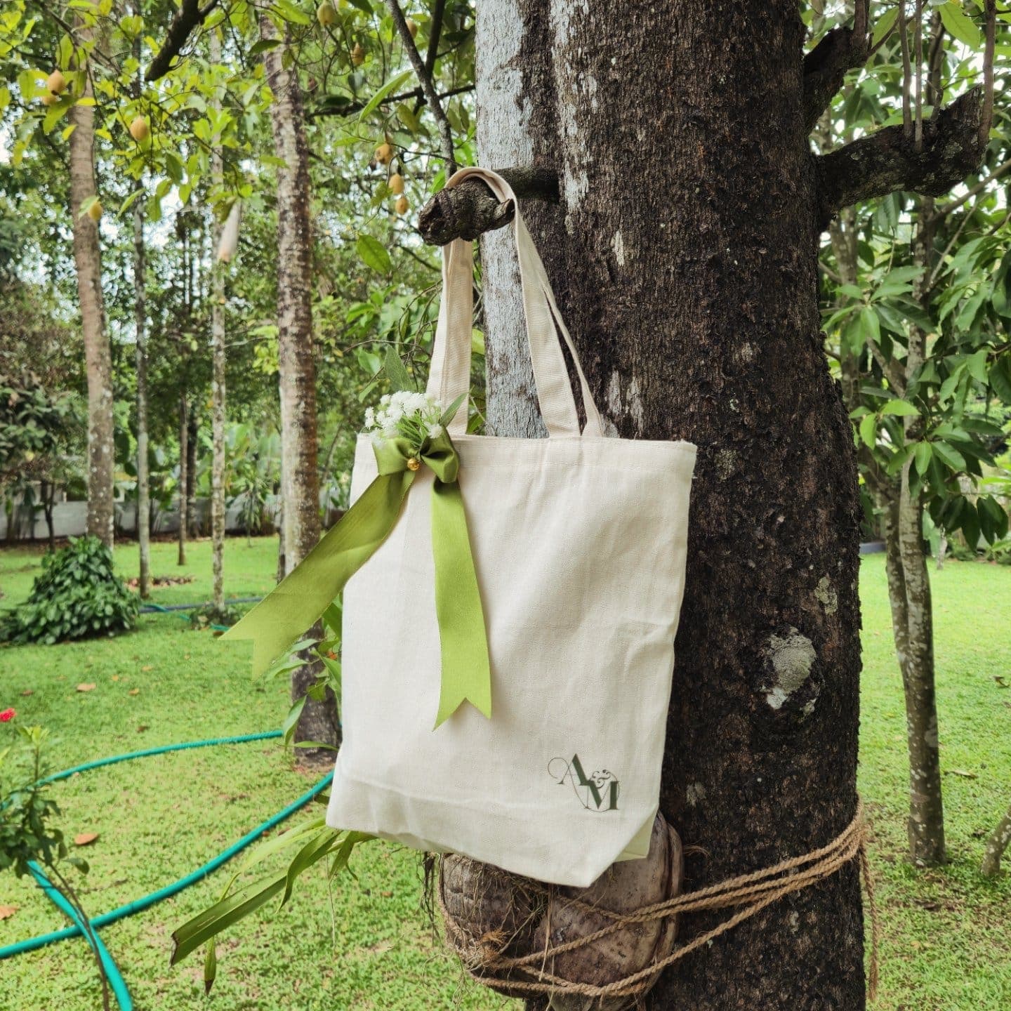 Natural cotton tote bag photographed in a garden setting